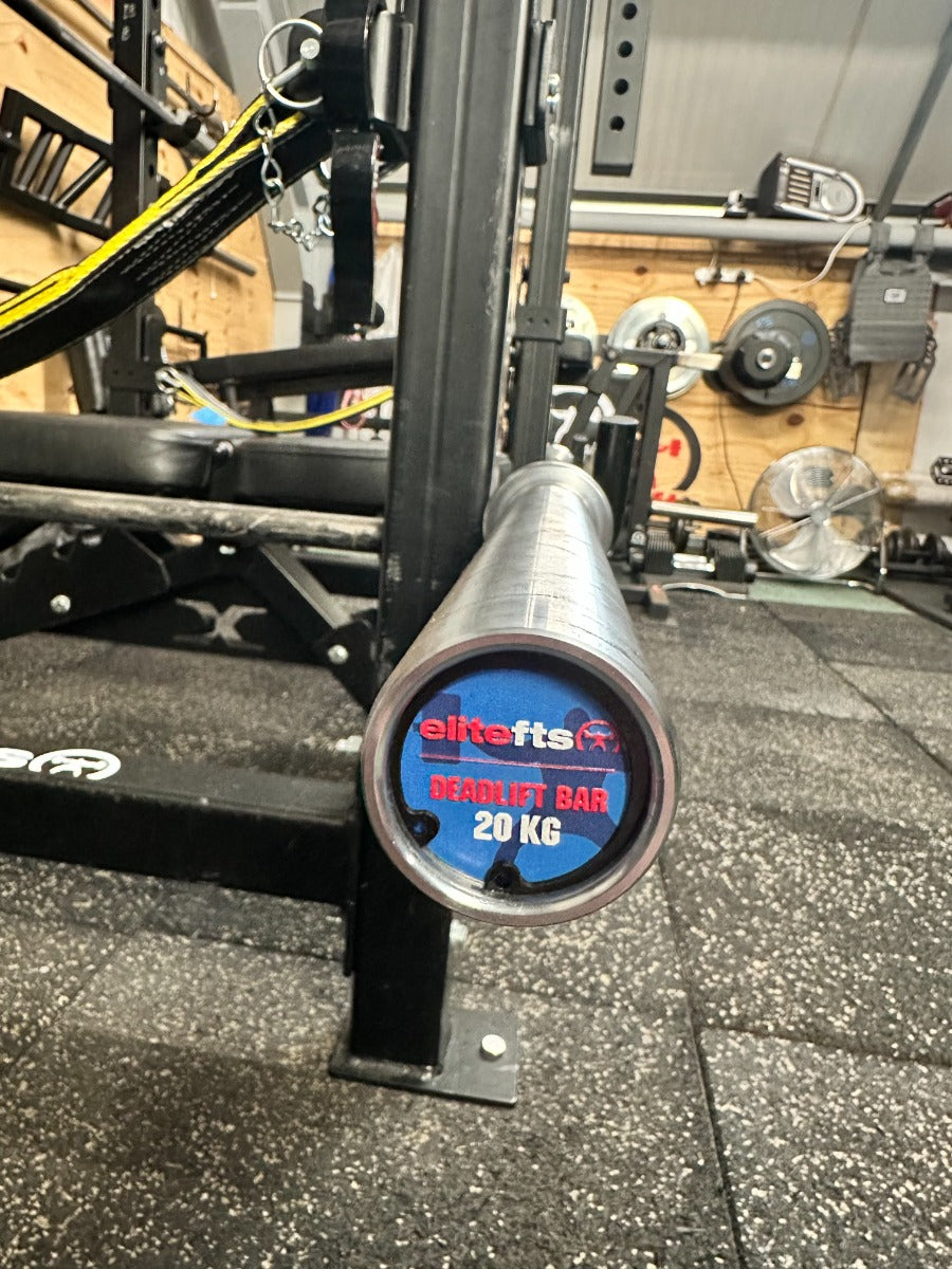 Weightlifting bar with Elitefts branding on a gym floor